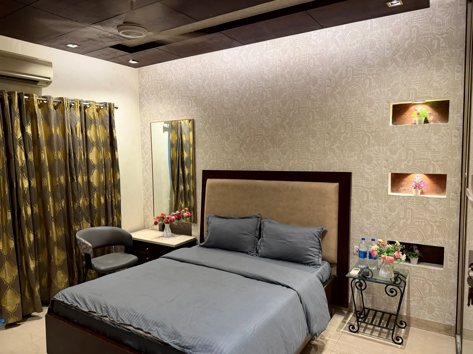 Sunlit bedroom with study desk and garden-facing window at Nivasa Villas, Gurugram