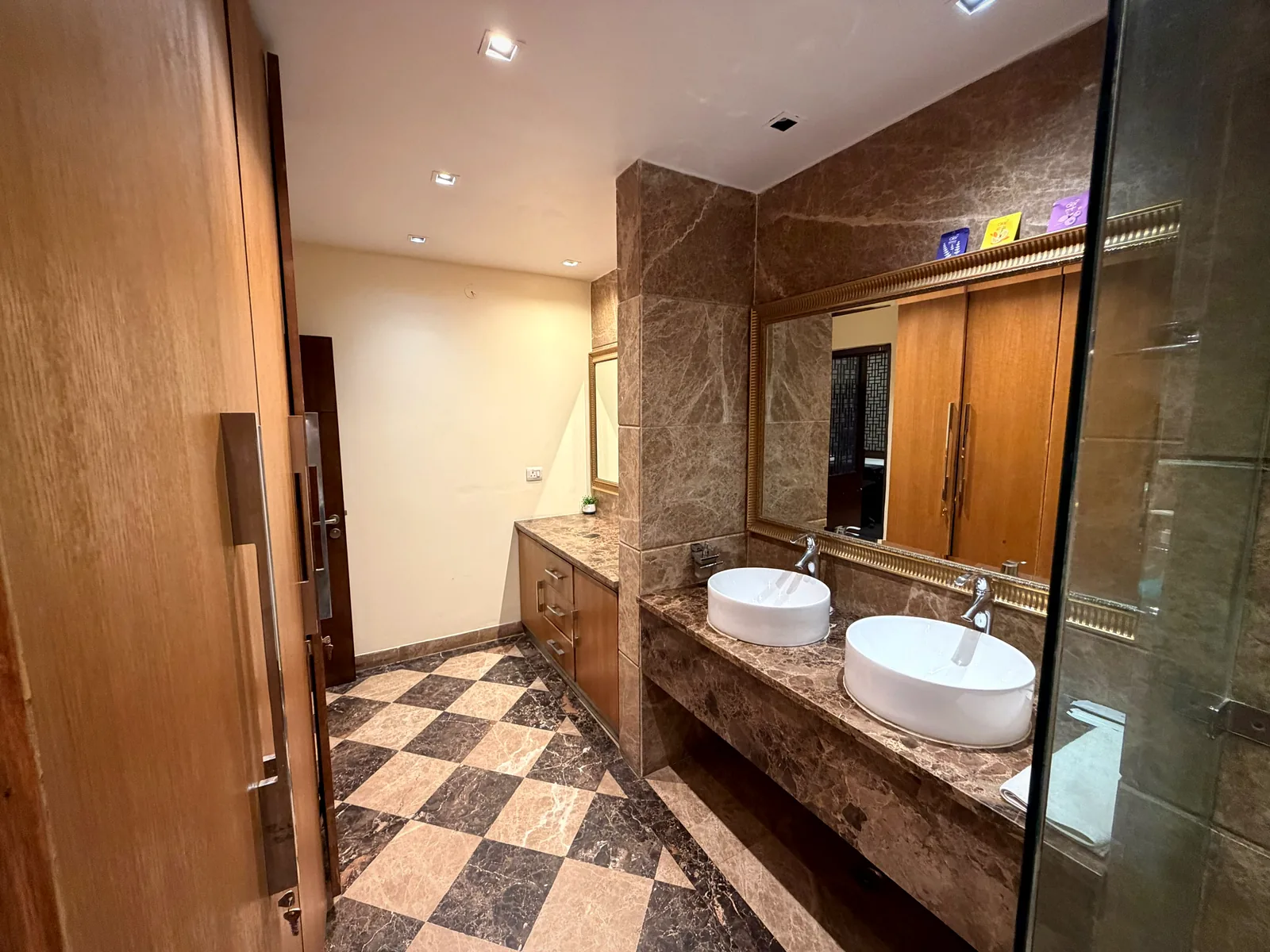 Chequered marble floor and double vanity in a bathroom at Nivasa Villas, Gurgaon