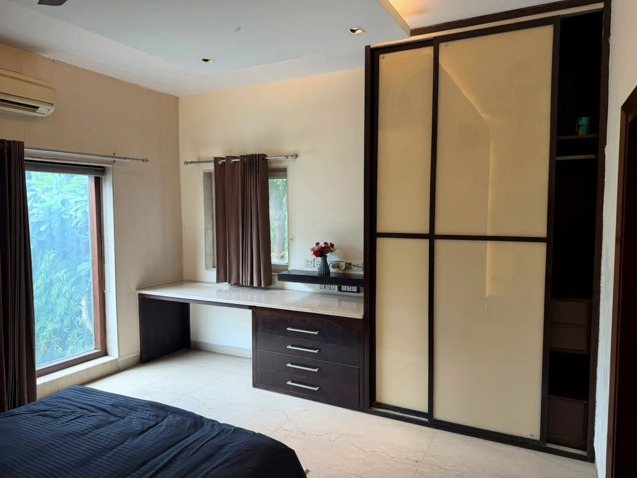 Dedicated workspace with long desk and garden-facing window at Nivasa Villas, Gurgaon