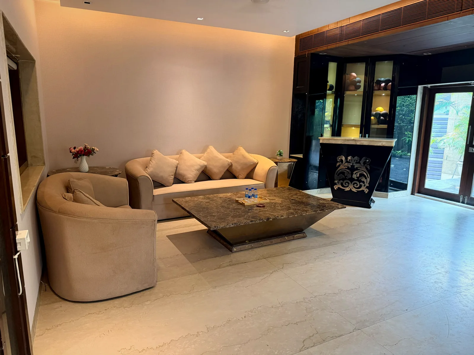 Open living hall with private bar counter and garden door at Nivasa Villas, Gurgaon