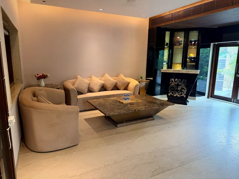 Open living hall with private bar counter and garden door at Nivasa Villas, Gurgaon