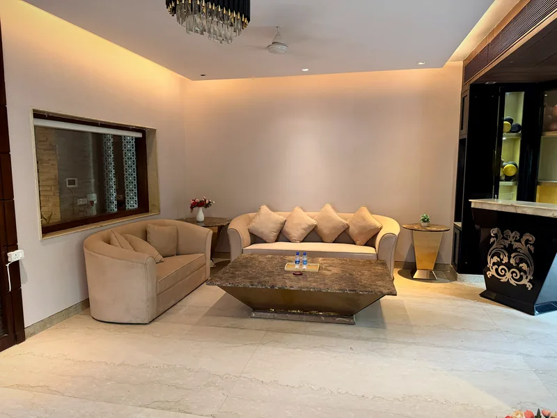 Chandelier-lit living area and private bar counter at Nivasa Villas, Gurugram